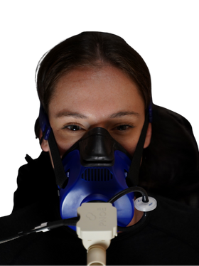 A woman wearing a medical mask with a tube attached to it